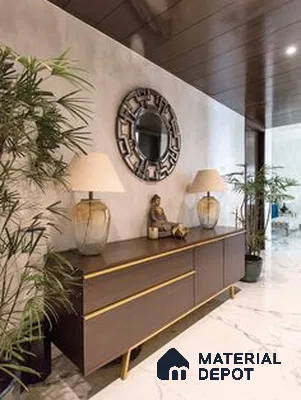 a kitchen with marble counter tops and wooden cabinetry, along with an island in the middle of the middle of the island with stairs leading to shop & more counter top space to an island in the middle of